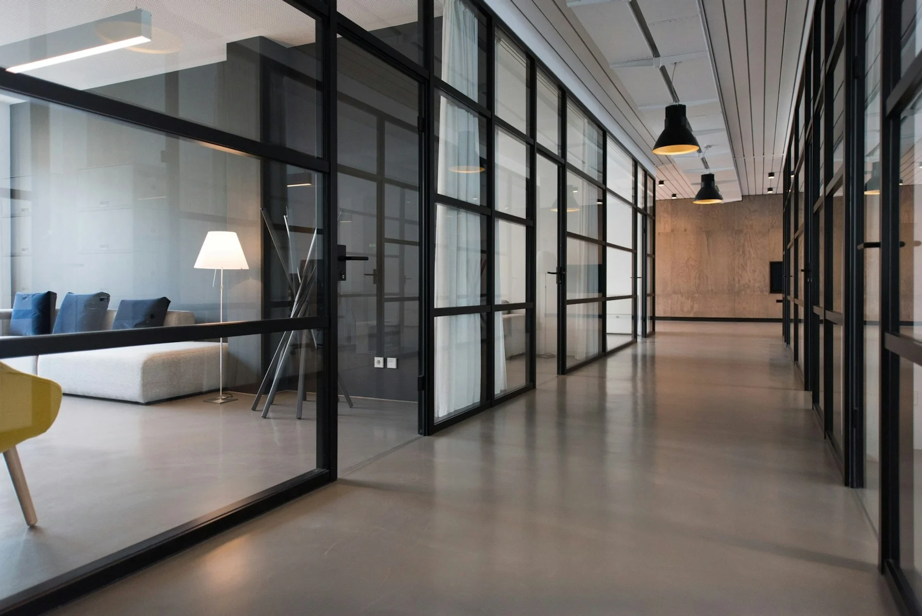 Contemporary office interior with glass partitions and finished flooring